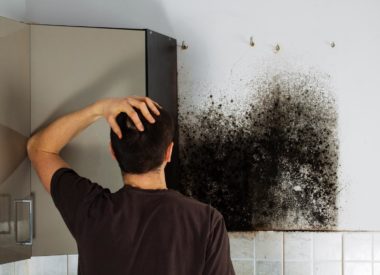 Man shocked to mold a kitchen cabinet. Man shocked to mold a kitchen cabinet.