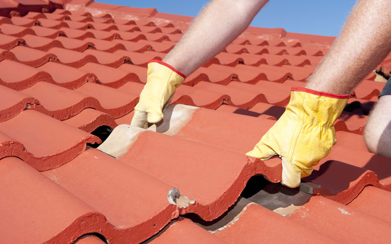 Worker Replacing Shingle to Prepare Roof for Spring